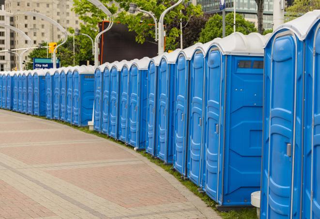 a line of portable restrooms at a sporting event, providing athletes and spectators with clean and accessible facilities in Alden